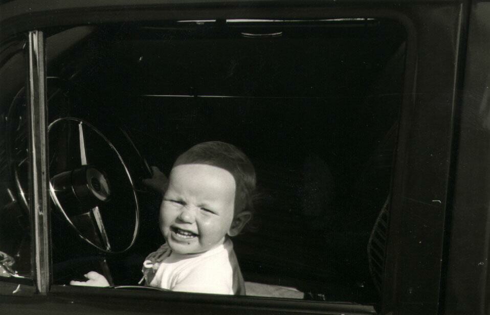 6 month old baby at the steering wheel of a car